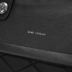Close-up of a black textured fabric with 'Gino Ferrari' branding.
