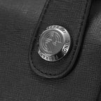 Close-up of a Ferrari logo on a black textured surface