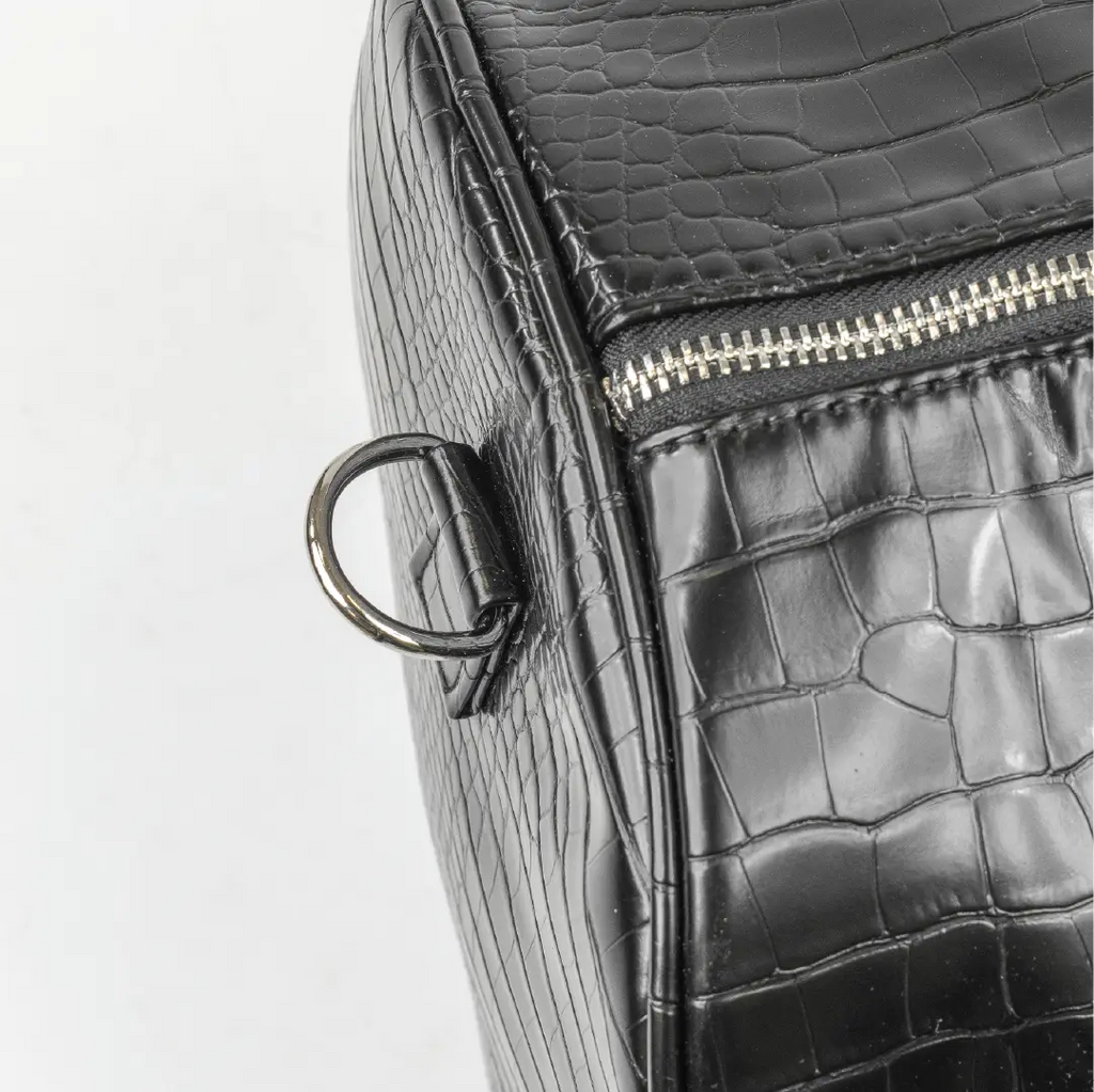 Leather-look textured bag with a pocket, handles and a silver zip with grey accents.