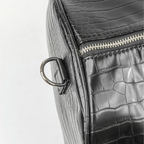 Leather-look textured bag with a pocket, handles and a silver zip with grey accents.