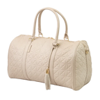 A close-up of a beige bag with patterned stitching, a gold zip and gold accents.