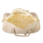 A close-up of a beige bag with cream interior, patterned stitching and a gold zip.