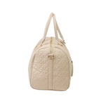 A close-up of a beige bag with patterned stitching, a gold zip and gold accents.