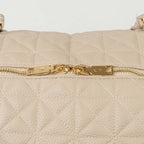A close-up of a beige bag with patterned stitching and a gold zip.