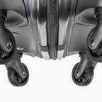 Close-up of a black suitcase with wheels on a white background