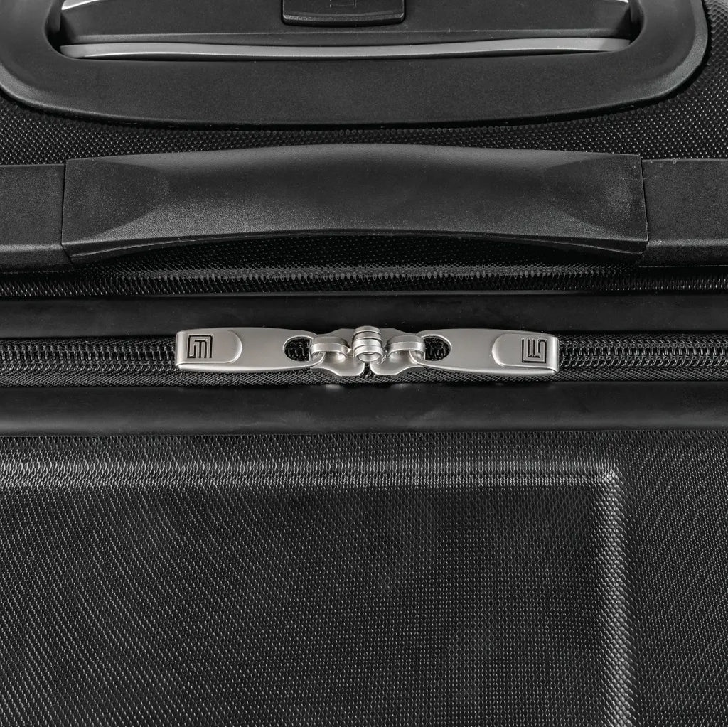 Close-up of a black suitcase handle and zipper area