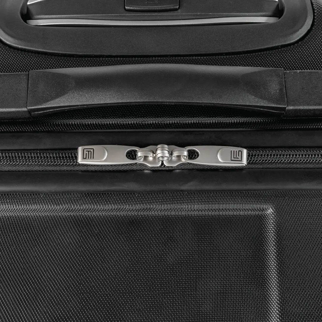 Close-up of a black suitcase handle and zipper area
