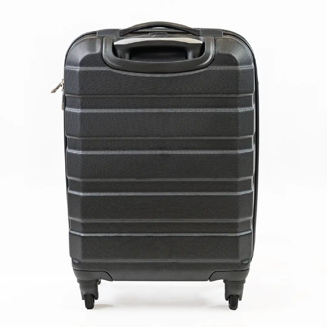 The back of a black cabin-sized suitcase.