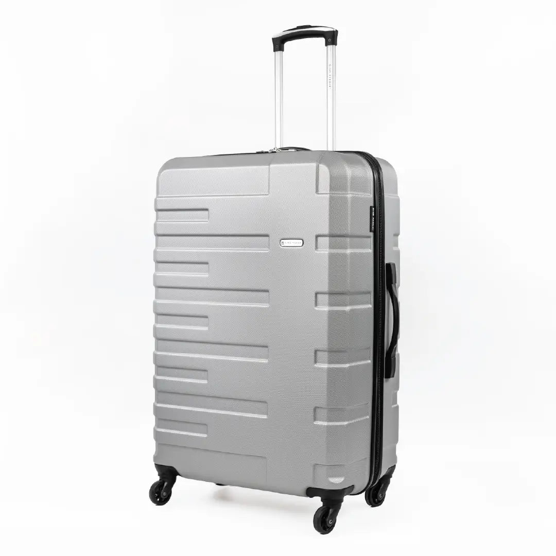 Silver suitcase with black wheels and handle on a white background
