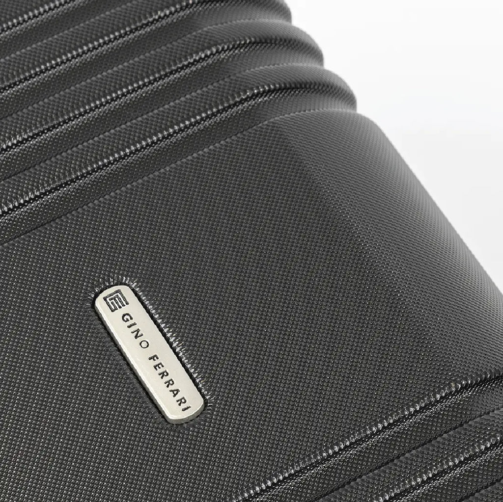 Close-up of a black suitcase with a visible brand logo on a white background