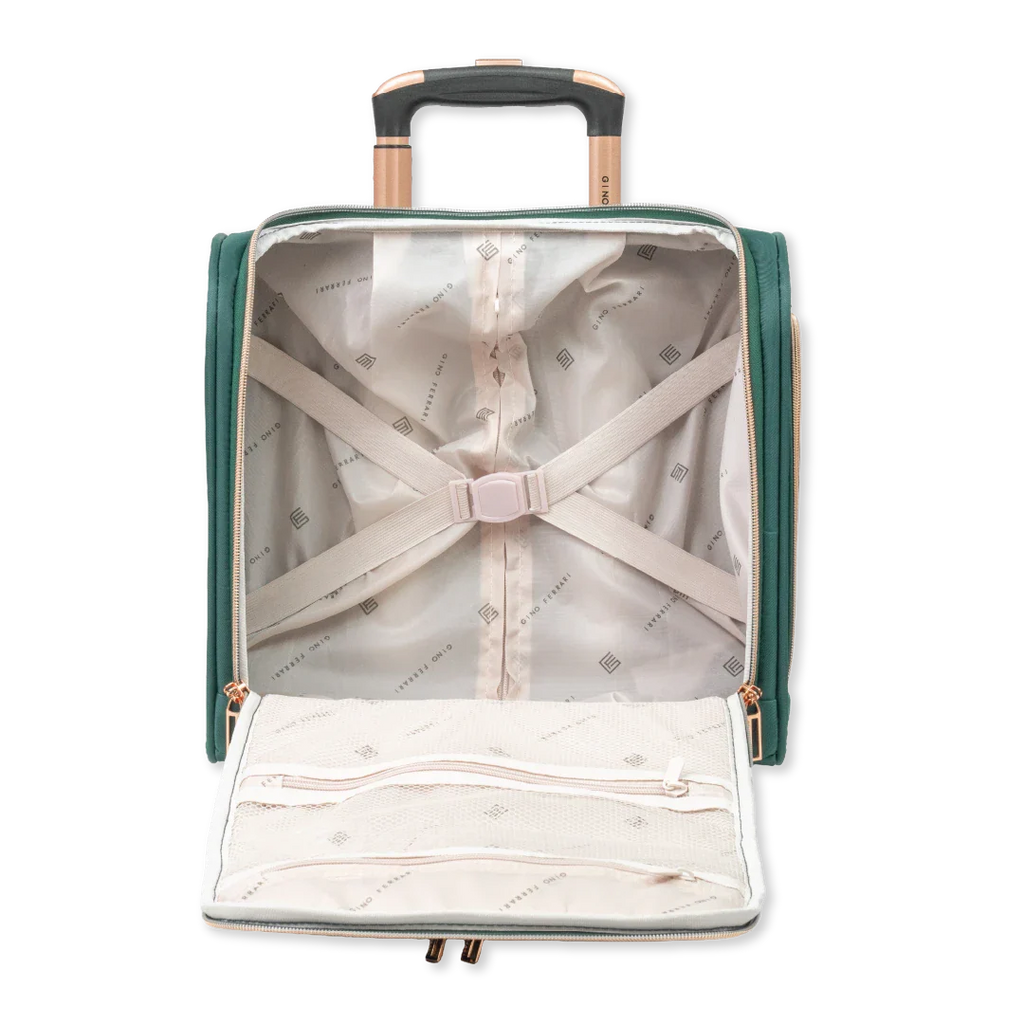 Green suitcase with a white shirt and beige pants inside on a white background