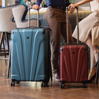 Two people with blue and red suitcases in a hotel lobby.