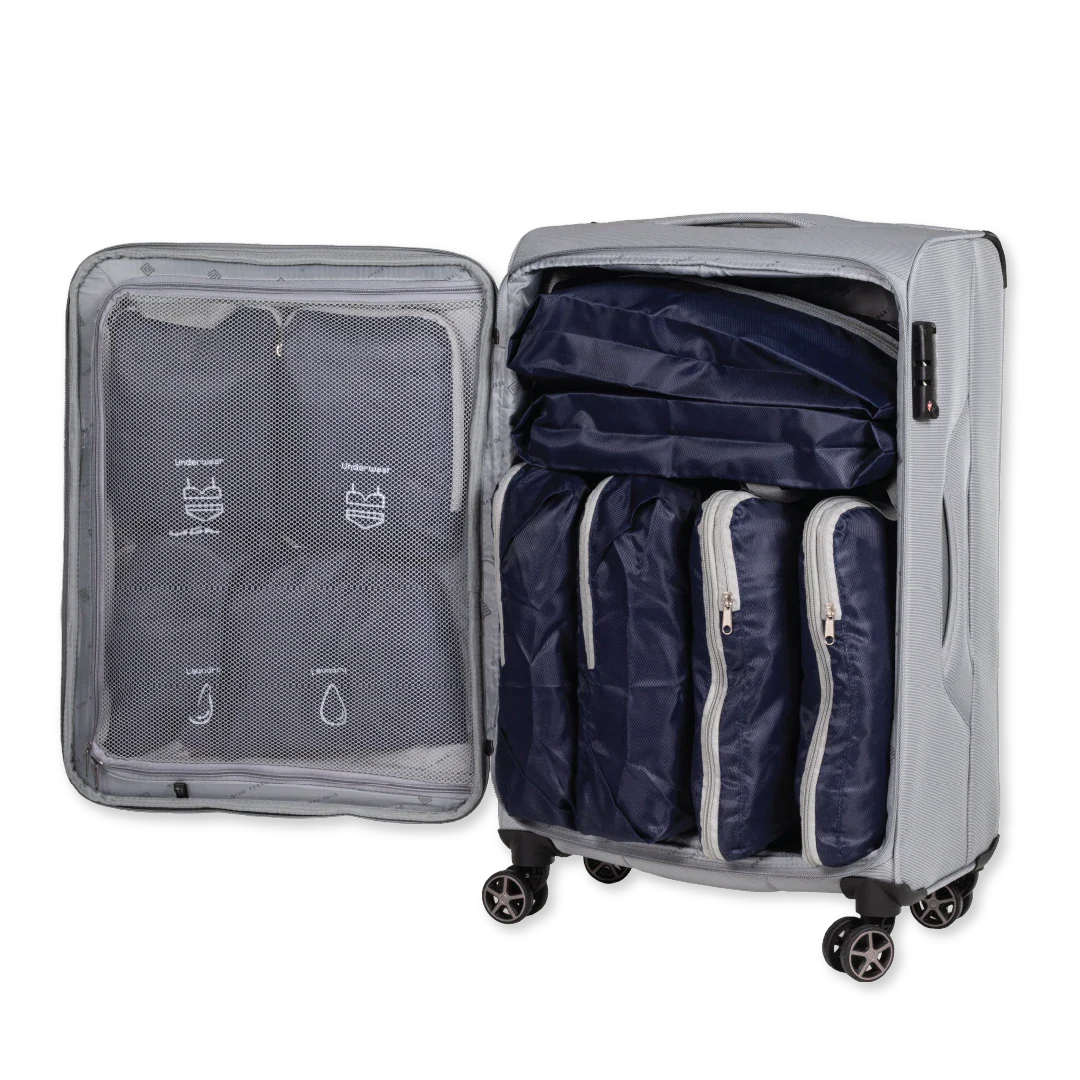 Gray suitcase with open lid showing navy packing cubes and clear compression bag.