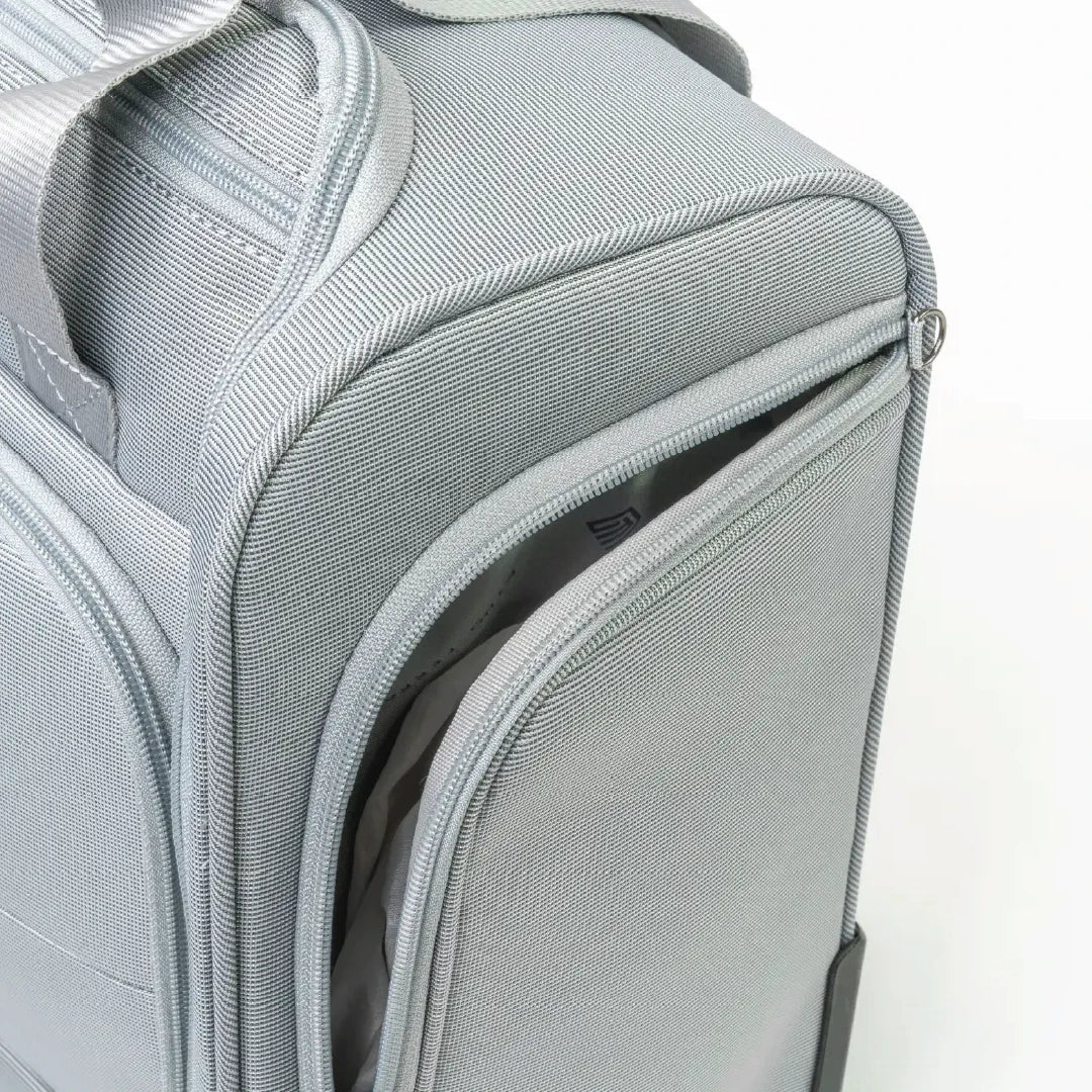 Gray backpack with a partially open front compartment on a white background