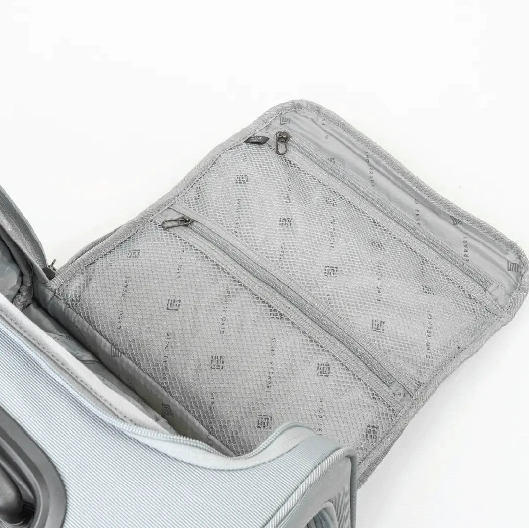 Gray travel organizer with mesh pocket on a white background