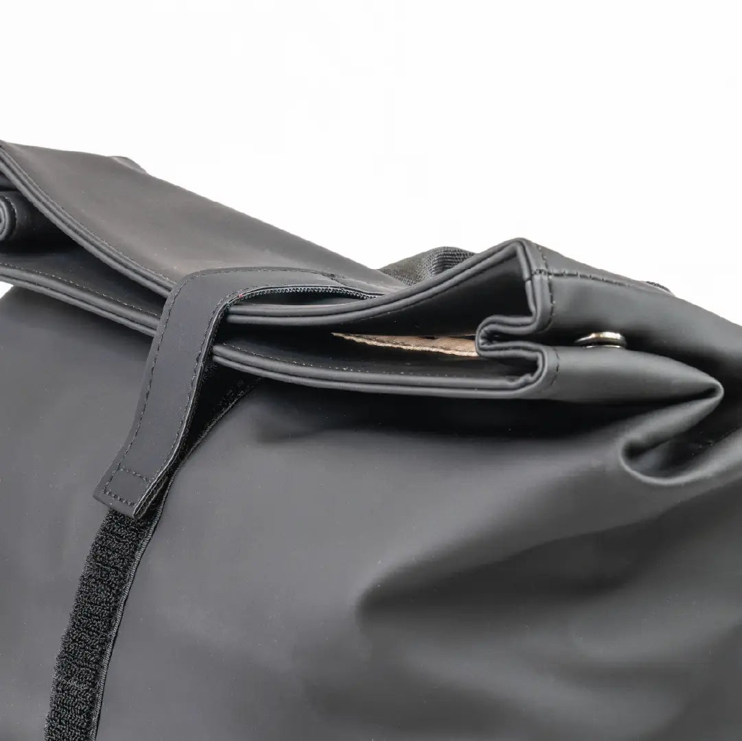 Close-up of a gray bag with a strap on a white background