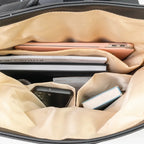 Beige travel organizer with compartments holding electronic devices.