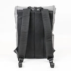 Back view of a gray backpack with black straps on a white background