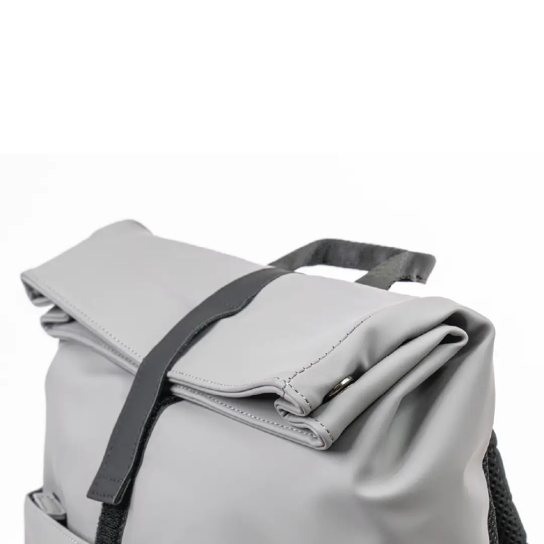 Light gray backpack with a black strap on a white background