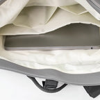 Close-up of a gray laptop bag with a laptop inside on a white background