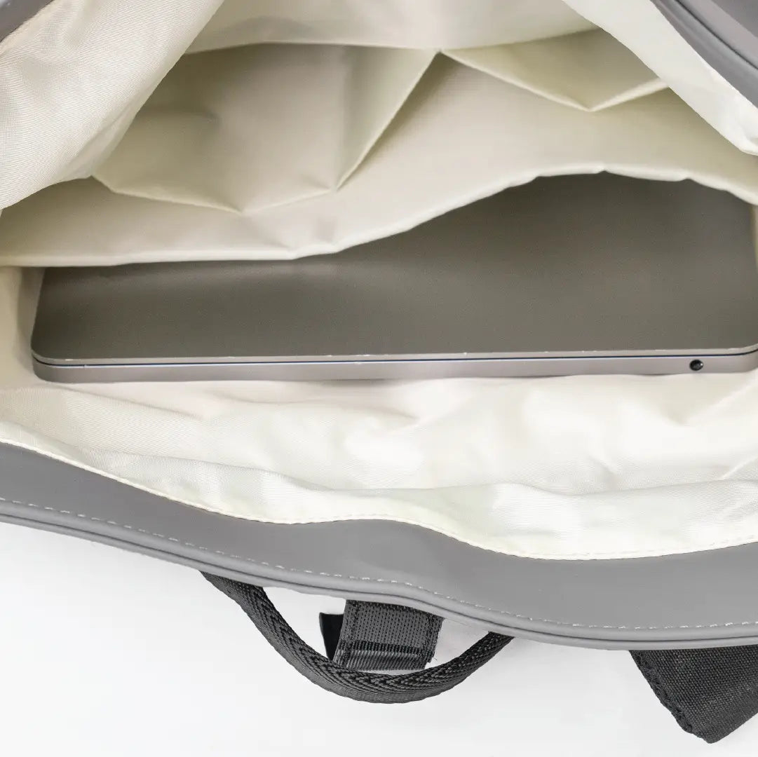 Close-up of a gray laptop bag with a laptop inside on a white background