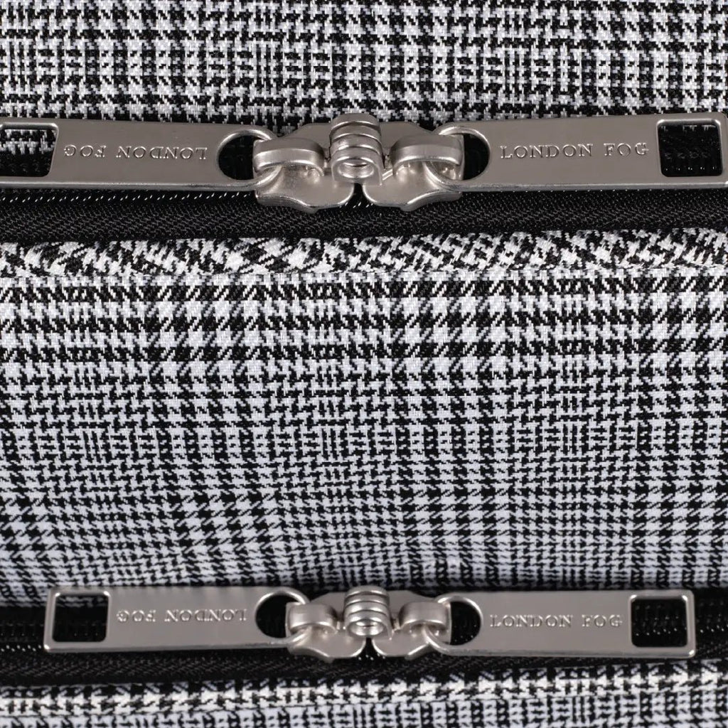 Close-up of a black and white houndstooth patterned product with metallic accents, featuring the brand 'London Fog'.