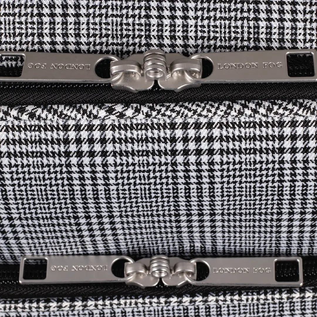 Close-up of a black and white houndstooth patterned product with metallic accents, featuring the brand 'London Fog'.