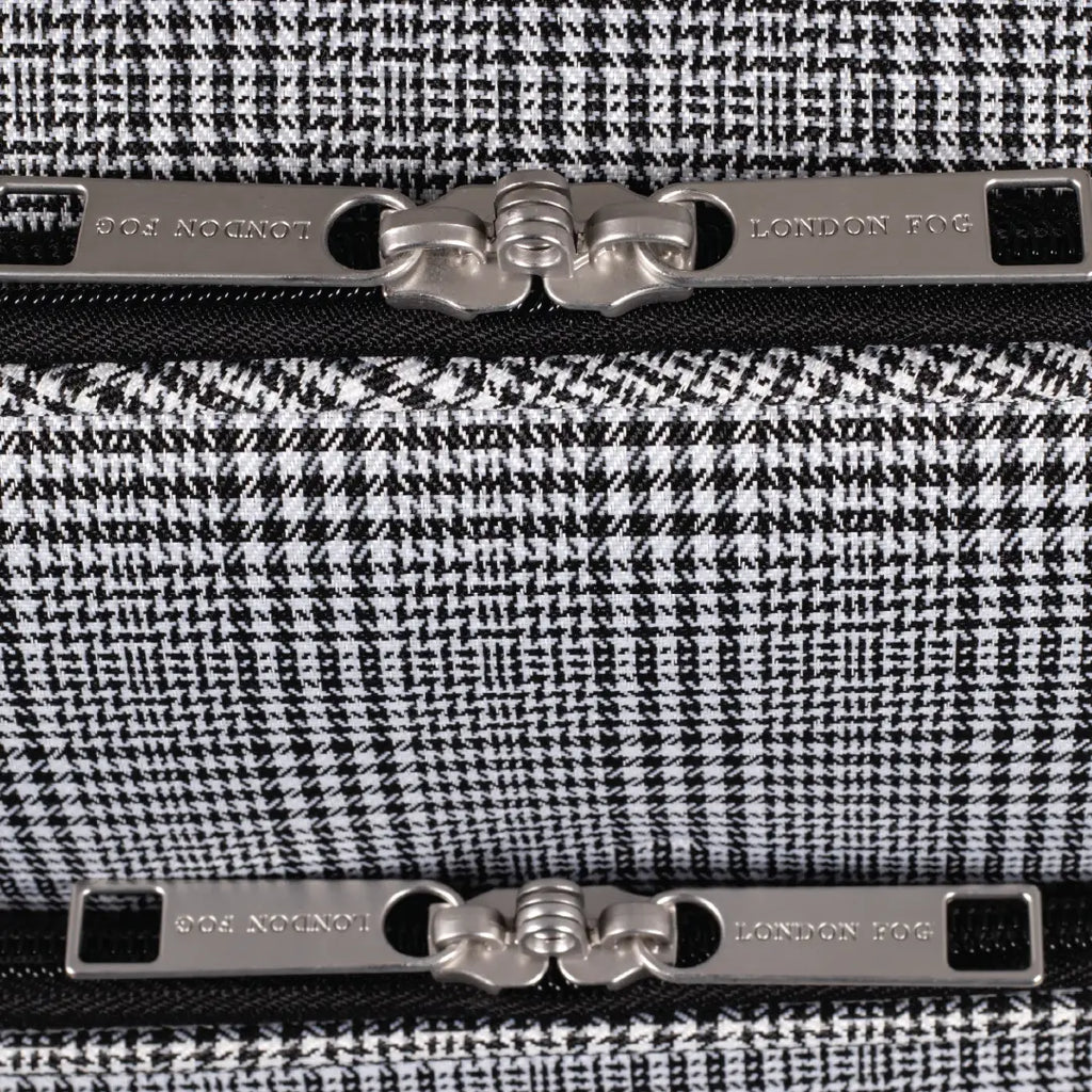 Close-up of a black and white houndstooth patterned product with metallic accents, featuring the brand 'London Fog'.