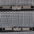 Close-up of a black and white houndstooth patterned product with metallic accents, featuring the brand 'London Fog'.
