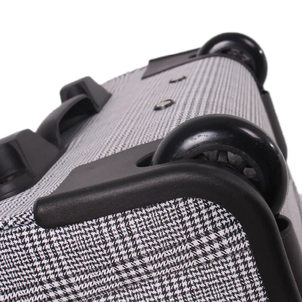 Close-up of a textured suitcase handle and body on a white background
