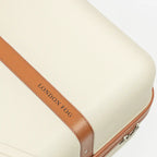 Beige suitcase with brown handle and trim on a white background