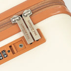 Close-up of a cream suitcase with 'London Fog' branding on the zipper pull.