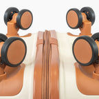 Close-up of a suitcase with wheels and a zipper on a white background