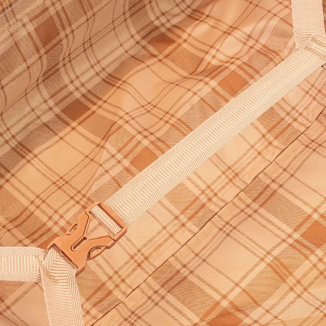 Close-up of a plaid fabric with a beige strap and buckle.