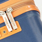 Close-up of a blue suitcase with an orange zipper and 'London Fog' branding.
