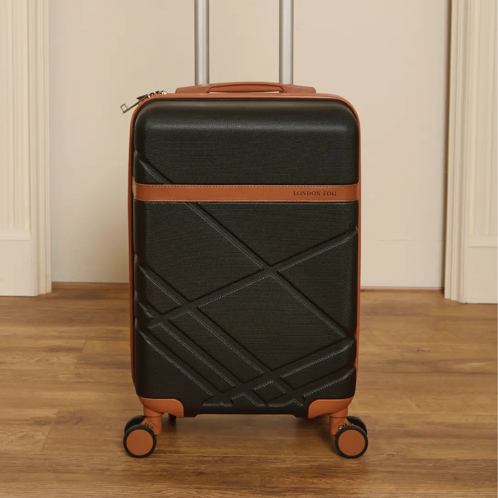 Black suitcase with brown accents on a wooden floor