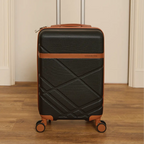 Black suitcase with brown accents on a wooden floor