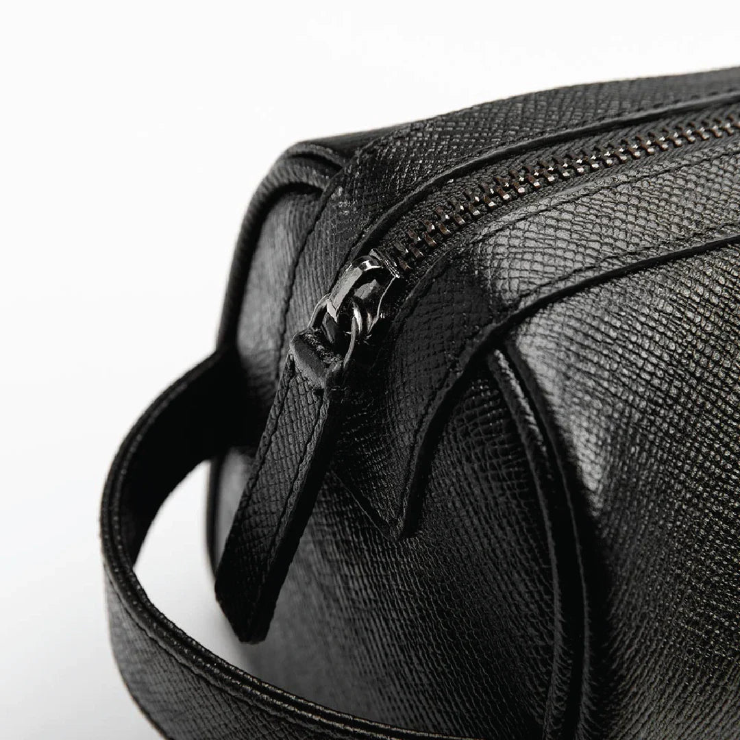 Black leather bag with a zipper on a white background