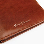 Brown leather wallet with branding on a white background